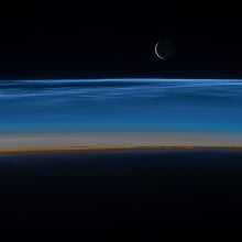 Noctilucent clouds hovering over Earth