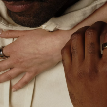 two people's hands with oura smart rings