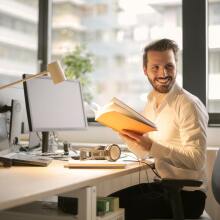 smiling man at his office desk