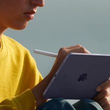 A person holding an iPad Mini with an Apple Pencil