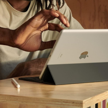 man using apple ipad 9th gen on a desk