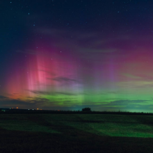 Wisconsin's night sky is glowing with the Northern Lights, as a geomagnetic storm is bringing vibrant pink and green colors, stealing the spotlight from the Perseus meteor shower.