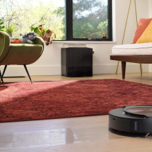 An iRobot Roomba on a living room floor.