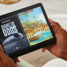 man looking at an Amazon Fire tablet 