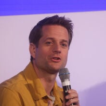 Sebastian Siemiatkowski, CEO of Klarna speaking on a microphone at an event