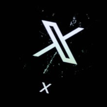 The X app. logo on a dark background.