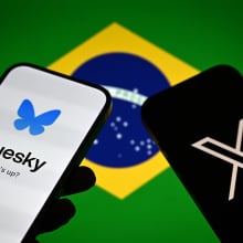 X and Bluesky on smartphones with Brazil's flag in the background