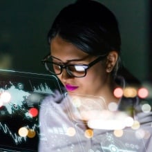 A female tech executive looking at a computer.