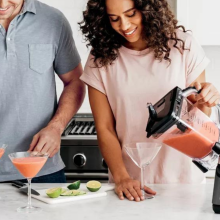 couple making frozen drinks with Ninja Professional Plus Duo blender