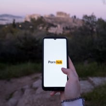 The Pornhub logo is being displayed on a smartphone screen