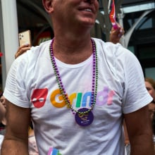 A bystander wears a Grindr t-shirt during the NYC Pride March