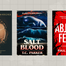 three horror books against a light gray grid