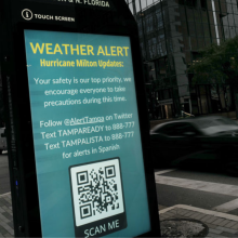 A weather alert is displayed along a sidewalk as Hurricane Milton churns in the Gulf of Mexico on October 07, 2024 in Tampa, Florida. Milton, which comes on heels of the destructive Hurricane Helene, has strengthened to a Category 5 storm as it approaches Florida’s Gulf Coast near Tampa, where it is projected to make landfall Wednesday.