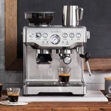 breville barista express surrounded by coffee and accessories