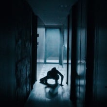 A woman crawls along a hallway in the dark in "MadS."