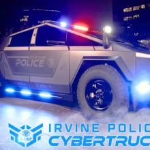 a police cybertruck lit up at night. 