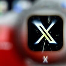 x logo blurred on a smartphone