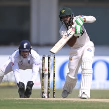 Pakistan batsman Aamer Jamal hits out watched by Jamie Smith