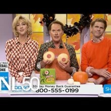 three white people in various holiday sweaters holding two sugar cookies 