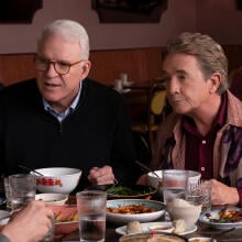 Steve Martin and Martin Short sit next to each other at a table in "Only Murders in the Building."