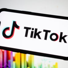 tiktok logo on a phone screen with colorful background