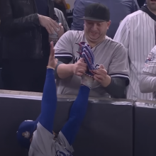 yankee fan taking ball from mookie betts