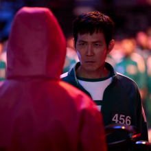 Lee Jung-jae as Seong Gi-hun in Squid Game Season 2, facing off with a game overseer.