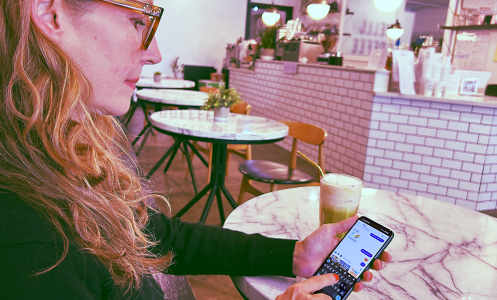 Michelle Kehm holding phone in hand with TextNow app messaging