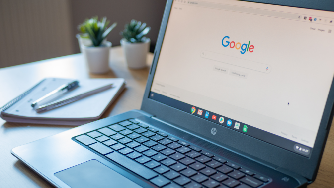 A black Chromebook open on a desk.