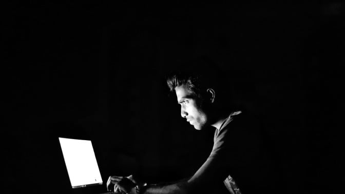 person uses computer in the dark