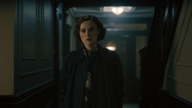  Keira Knightley in "Boston Strangler." a reporter stares down a dark hallway. 