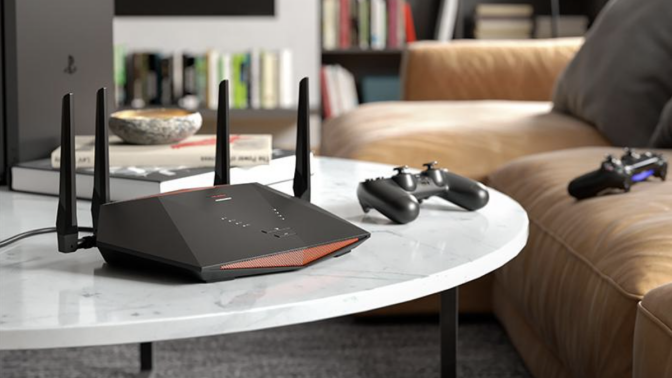 netgear router on table next to gaming controller