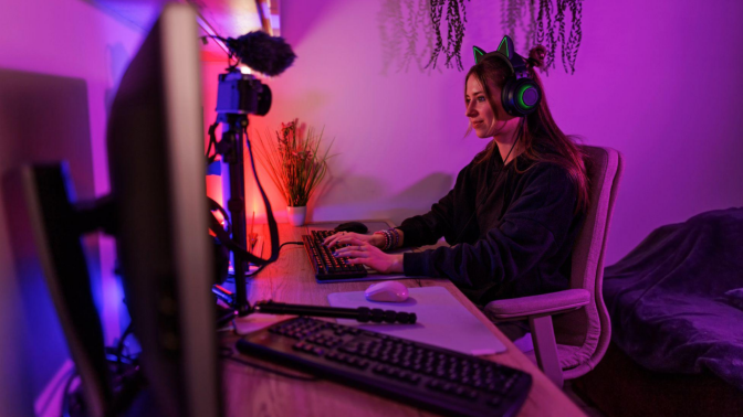 Girl streaming playing video game on desktop PC