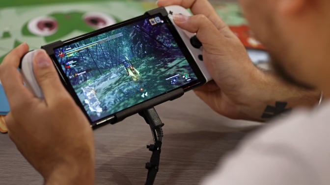 A gamer plays a video game on a Nintendo Switch console, OLED model during Paris Games Week 2022 at Parc des Expositions Porte de Versailles on November 03, 2022 in Paris, France. 