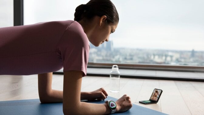 a person doing yoga wears the samsung galaxy watch 6