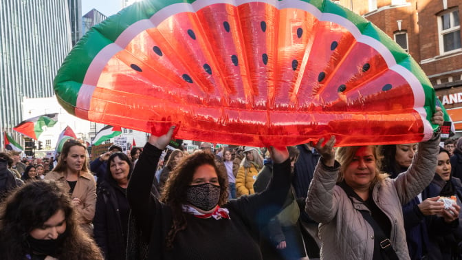 Pro-Palestinian protesters holding an inflatable water melon, a symbol of resistance in occupied Palestine, take part in an Armistice Day march from Hyde Park to the US embassy to call for an immediate ceasefire in Gaza on 11th November 2023 in London, United Kingdom. The march was organised by Palestine Solidarity Campaign (PSC), Stop the War Coalition, Friends of Al-Aqsa, Muslim Association of Britain and Palestinian Forum in Britain. Mass Palestinian solidarity rallies have been held around the world for a fifth consecutive weekend to call for an end to the Israeli bombardment of Gaza.