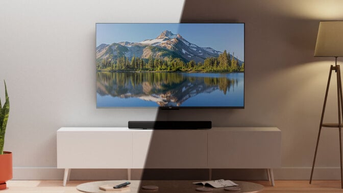 Amazon QLED TV on TV stand with light hitting half of the TV