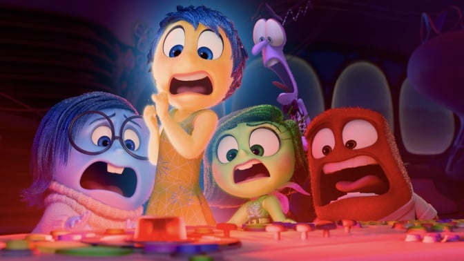 The emotions from "Inside Out 2" scream while looking at a flashing red button.