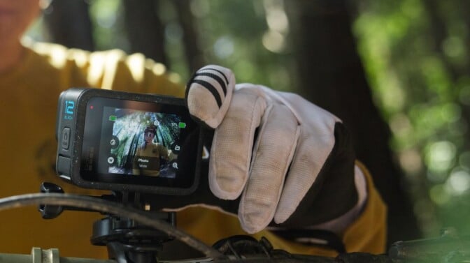 A GoPro Hero 12 camera is mounted on a mountain bike 