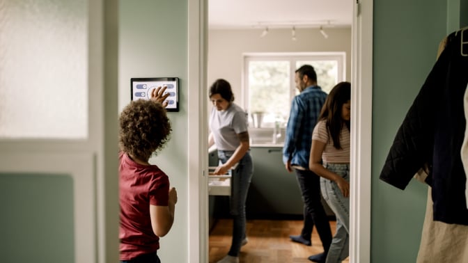 a family inside of their home uses smart home devices