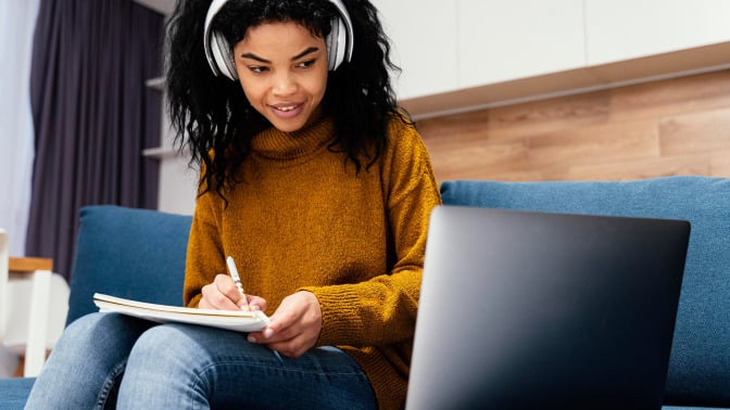 young woman taking online class with laptop