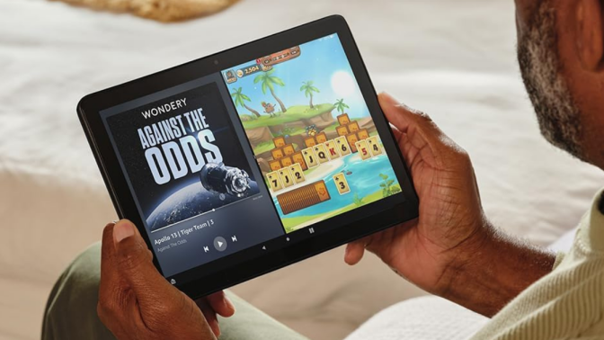 man looking at an Amazon Fire tablet 