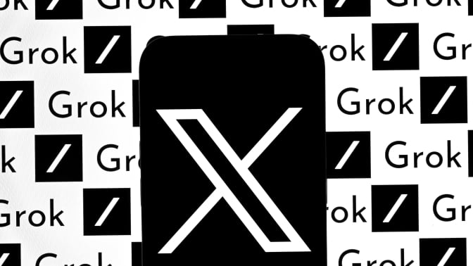 A phone displaying the X logo in front of a screen displaying the Grok logo.