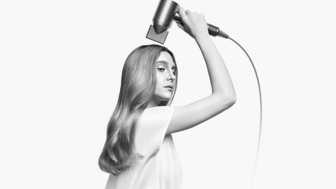 woman using the dyson supersonic hair dryer 