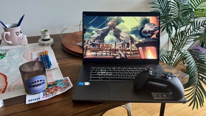 Acer Chromebook 516 GE gaming laptop on crowded desk next to indoor plant