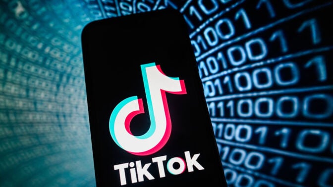 TikTok logo in front of binary code