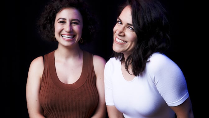 Abbi Jacobson and Ilana Glazer smiling in a portrait. 