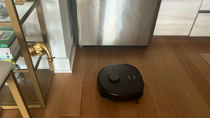 An Eufy X10 Pro Omni robot vacuum on a kitchen floor