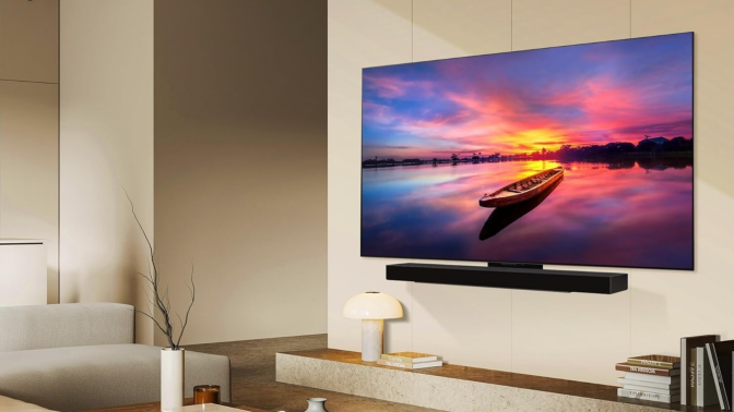 An LG OLED TV mounted on a living room wall.