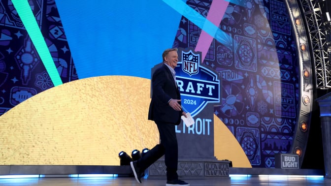 nfl commissioner roger goodell walking across the nfl draft stage